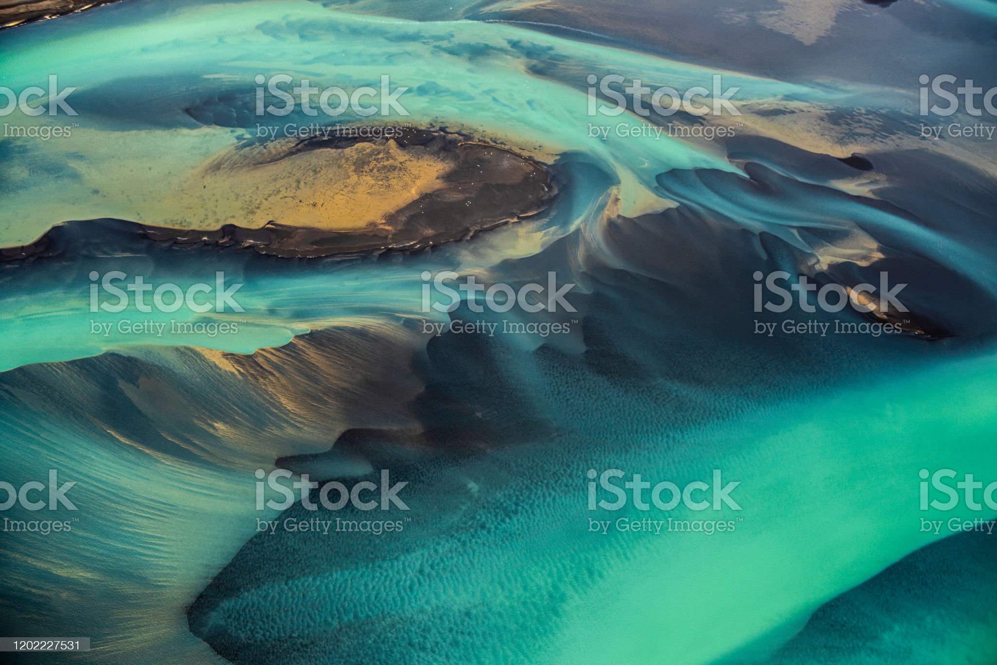 Helicopter view of wonderful turquoise-colored glacial rivers in Iceland.